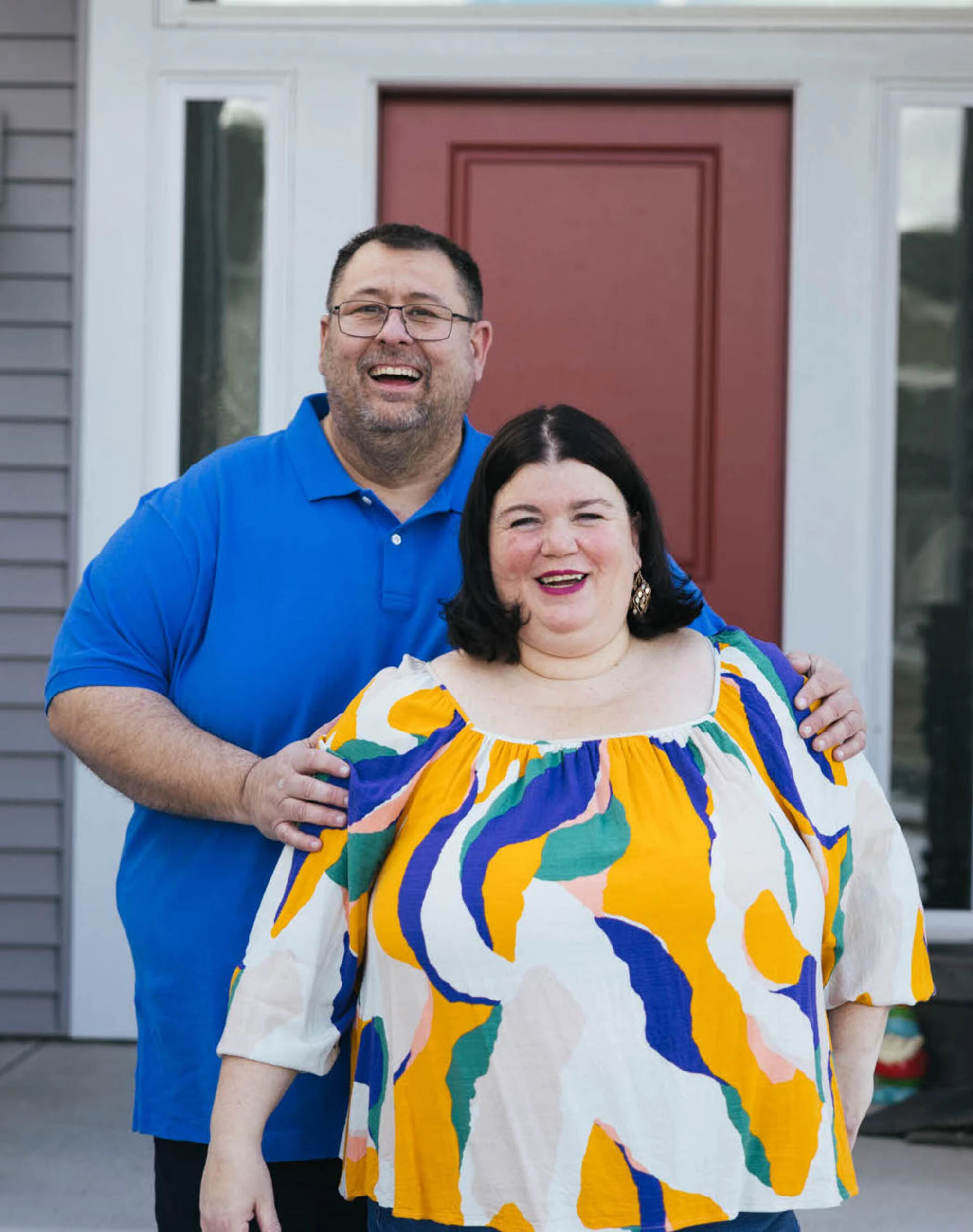 Tammilee and John outside their home.